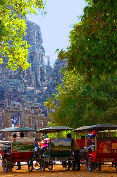 Angkor, Cambodia, circa January 2013, Unidentified tuk-tuk drivers await fare at the exit of Bayon Prasat temple during the festive season, Cambodia, circa Jan 2013