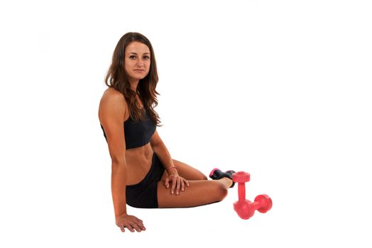 Young woman in the studio with weights working out