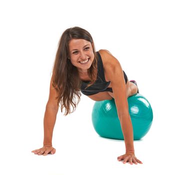 Young woman with sport gymnastic ball in the studio