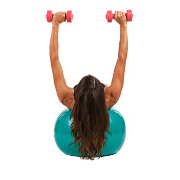 Young woman with sport gymnastic ball in the studio