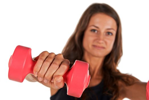 Weights in the hands of a young woman in the studio