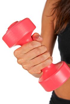 Weights in the hands of a young woman in the studio