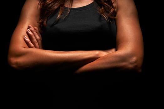 Upper body of a muscular woman in a studio