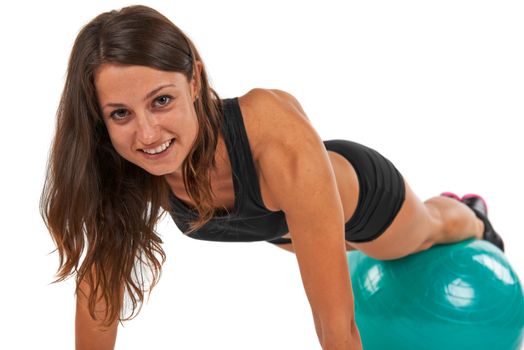 Young woman in the studio with fitness ball against white background