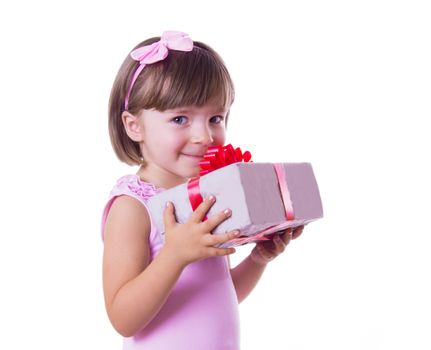 Smiling little girl holding present box over white