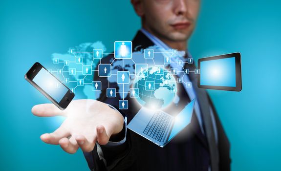 Image of business person holding devices in hands