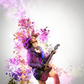 Young attractive rock girl playing the electric guitar