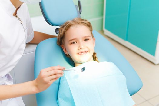 Little girl sitting in the dentists office