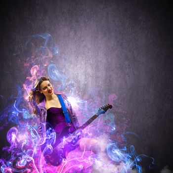 Young attractive rock girl playing the electric guitar