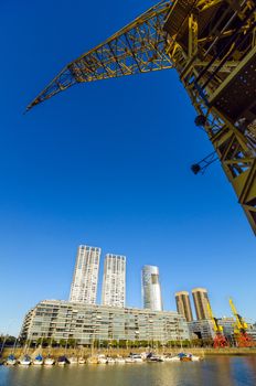 Waterfront of Puerto Madero in Buenos Aires, Argentina with a tall yellow crane rising above