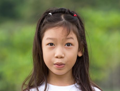 Outdoors portrait of beautiful Asian young girl