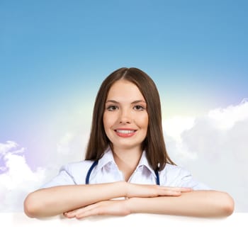 Young attractive female doctor put her hands on the blank banner, place for text