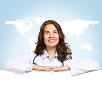 Young attractive female doctor put her hands on the blank banner, place for text