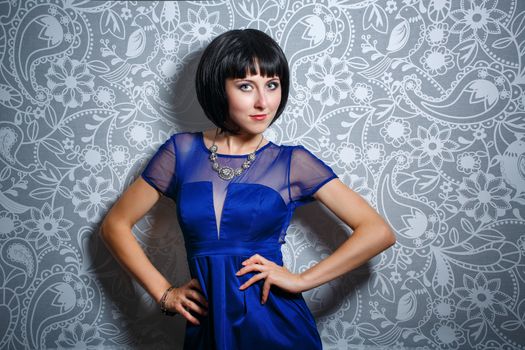 Beautiful young brunette woman shot in studio on a background of interior