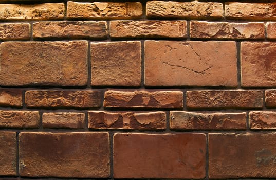 Wall for background texture with damaged brown bricks
