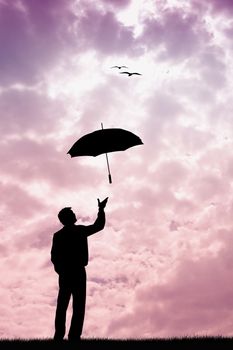 Man with umbrella at sunset