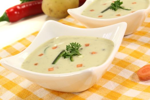 fresh vegetable soup with carrots on a light background