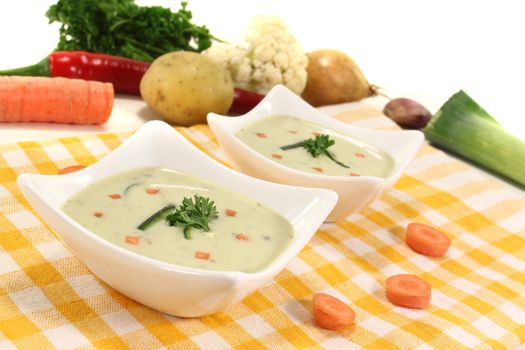 freshly cooked vegetable soup with carrots on a light background