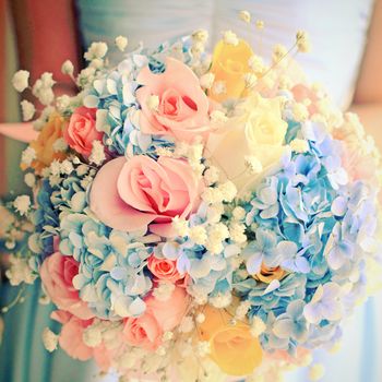 Bride or bridemaid with bouquet, closeup with retro filter effect 
