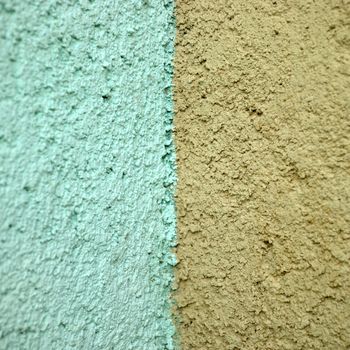 turquoise and orange stucco wall close up