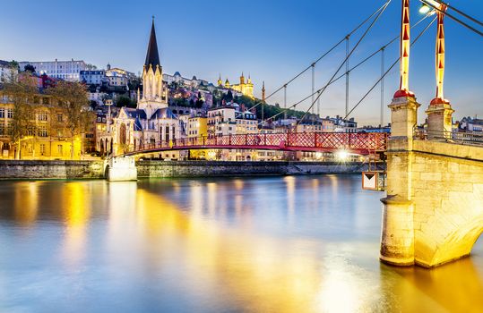 night view from St Georges footbridge in Lyon city with Fourviere cathedral, France