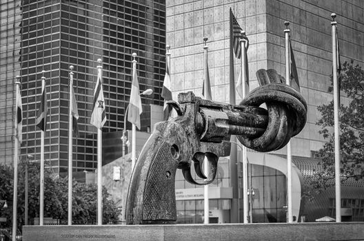 NEW YORK - MAY 28: Non Violence Sculpture at the United Nations Headquarters in May 28, 2013. The in New York, New York. A Gun tied in a knot as symbol for reaching peace, gift from the Government of Luxembourg