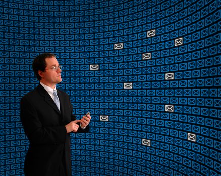Man monitoring an array of emails among a field of blue message icons
