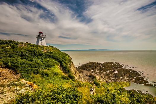 Lighthouse of the eroded cliff and beach located in Cape Enrage New Brunswick Canada