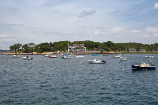 An array of recreational watercraft are tied up outside a resort area in Gloucester, MA