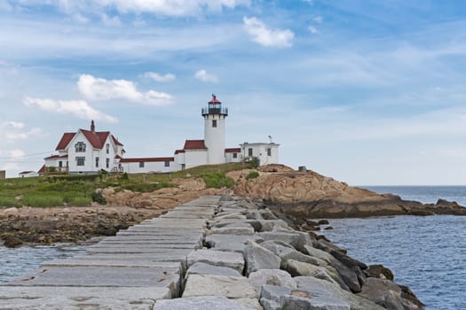 The lighthouse and the living quarters are shown in this image from Gloucester, MA.