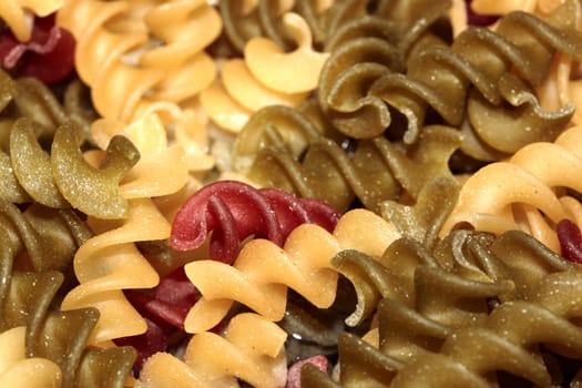 Macro of multi-colored spiral pasta
