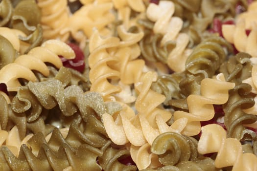 Macro of multi-colored spiral pasta