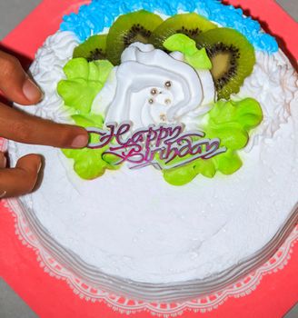 Birthday cake with white and green icing