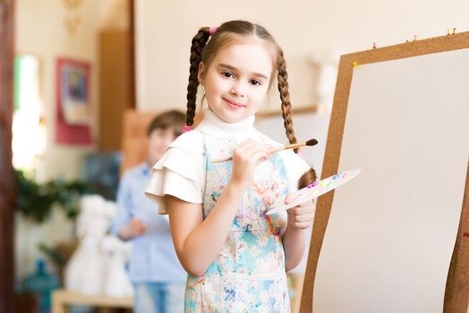 portrait of a girl standing next to his easel, a drawing lesson