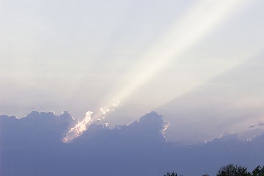 Sunset  clouds in formation to hide the sun and showing a beam of light.