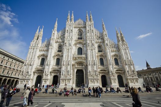 Milan, Italy - March 2013: Tourists at Piazza Duomo in Milan, famous city of Italy. From 2006, Milan was the 42nd most visited city worldwide, with 1.9 million annual international visitors.