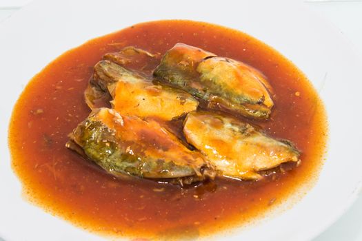 Canned fish in tomato sauce on dish