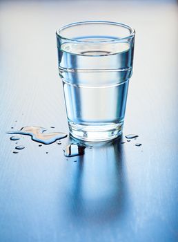 Pure water in glass on a table, shallow focus