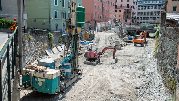 drill rig and excavators on the bed of the stream to work on the site