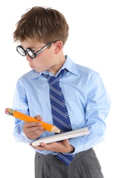 Schoolboy wearing large glasses, holding a book and pencil is looking sideways with much interest.  White background, 
