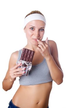 Portrait of young happy smiling woman eating chocolate isolated