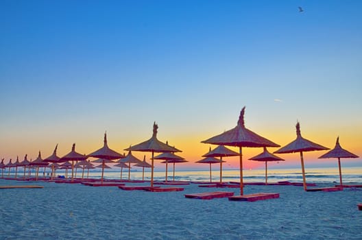 Sunrise under parasol on the Black Sea  beach