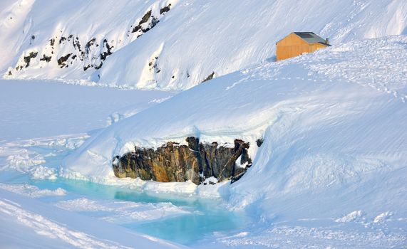 House on glacier in Greenland in spring time