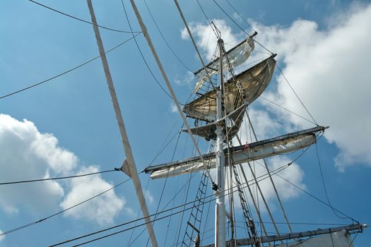 Sailing masts of traditional vintage wooden tallships sky background                               