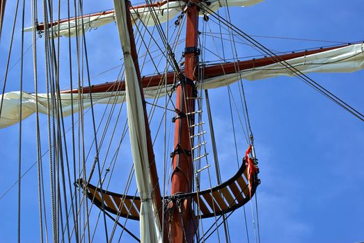Sailing masts of traditional vintage wooden tallships sky background