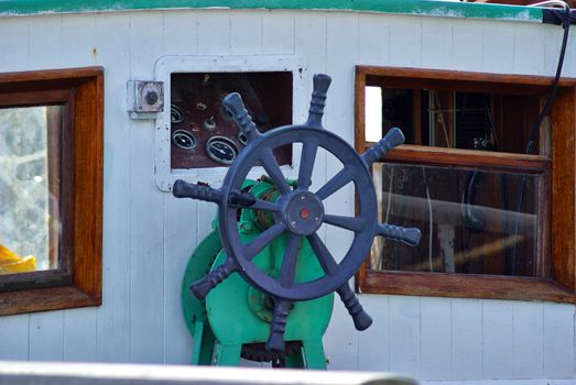 Beautiful traditional wooden ship steering wheel on a  sailing boat