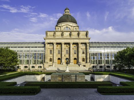 Picture of the Bavarian State Chancellery in the Otto park in Munich with green trees and blue sky on a sunny summer day