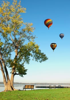 lake and colorful hot air balloons on a beautiful day