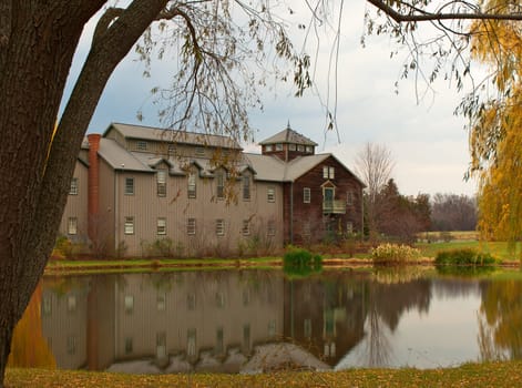 autumn scene with building and pond