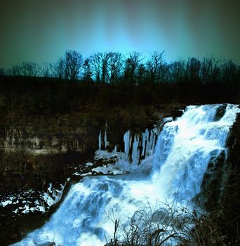 waterfall in winter at nighttime scene